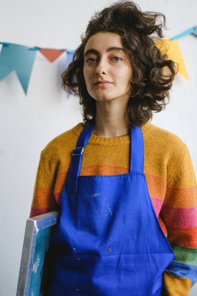 Painter standing with canvas frame in workshop